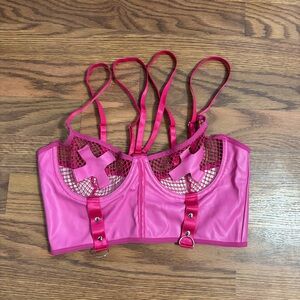pink PVC leather bra top with a cross motif